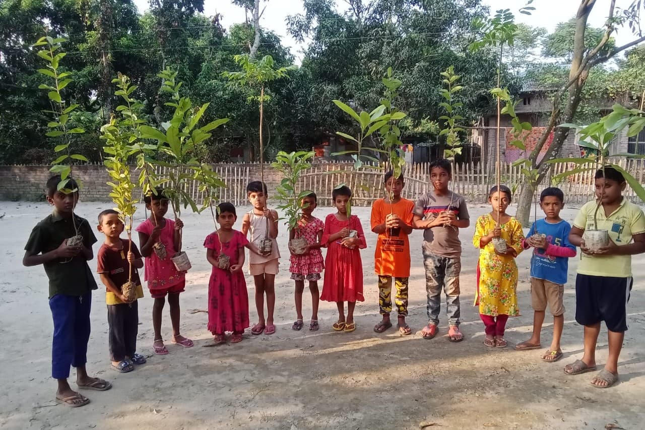 Children with tree saplings from GCO's One Tree for One Child program